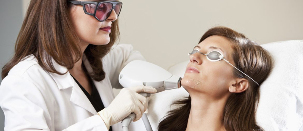 The beautician carrying out the procedure of Laser rejuvenation